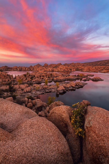 Scenic view of rocks against sky during sunset
