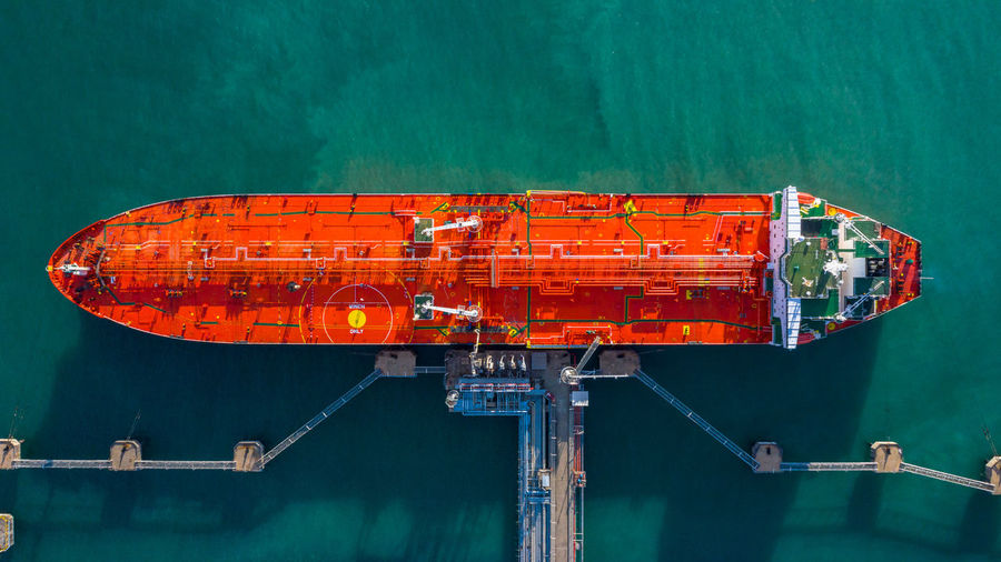 Aerial view tanker ship unloading at port, business import export oil with tanker ship