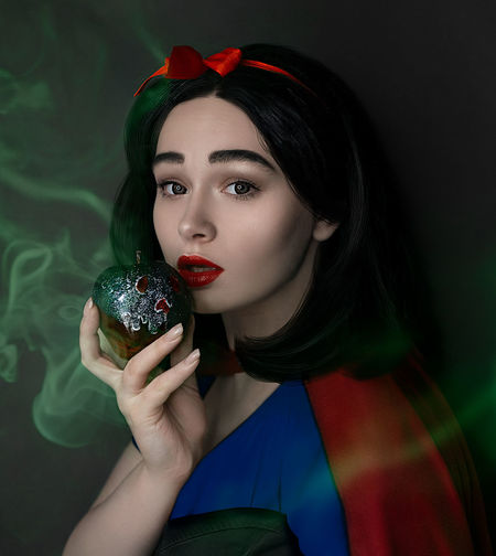 Portrait of woman holding red umbrella