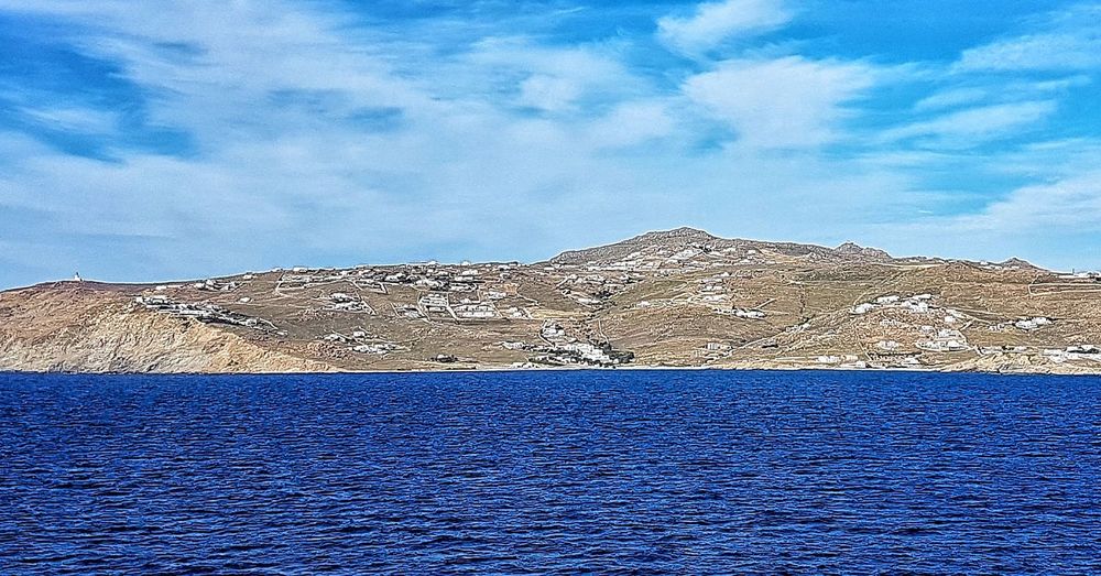 Scenic view of mountain against blue sky