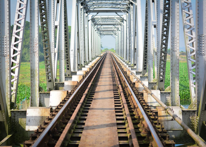 Railroad tracks amidst bridge