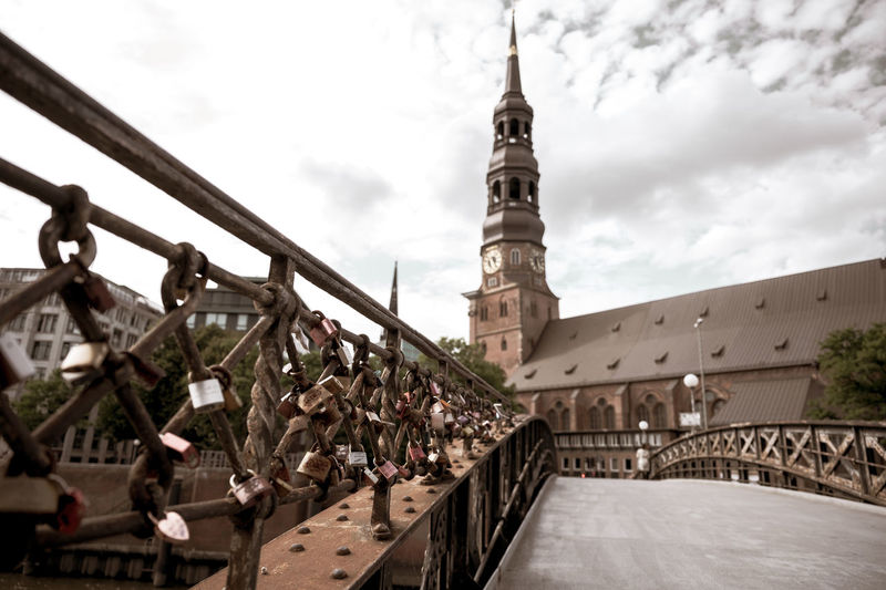 Low angle view of bridge and buildings against sky
