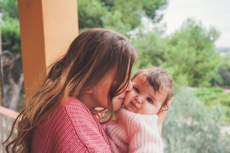 Portrait of mother and daughter outdoors