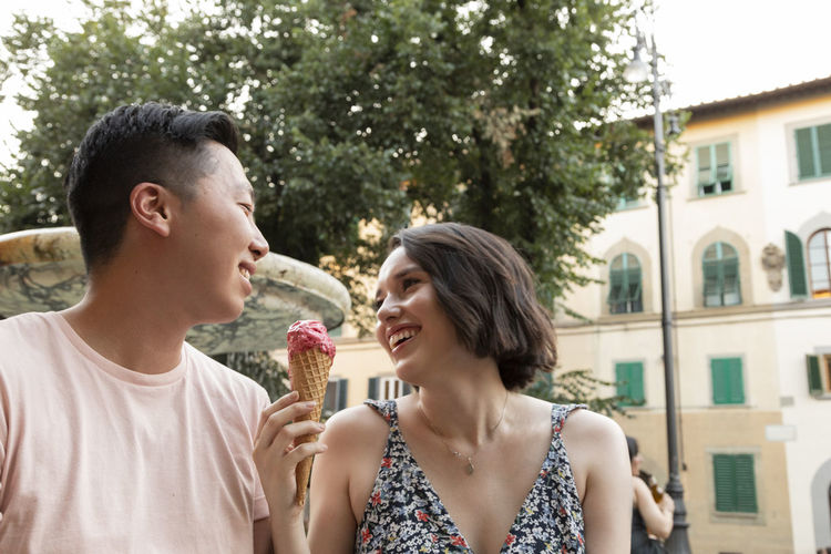 Happy couple enjoying gelato in florence italy