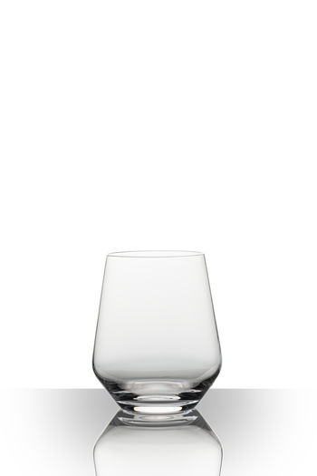 Close-up of empty glass over white background