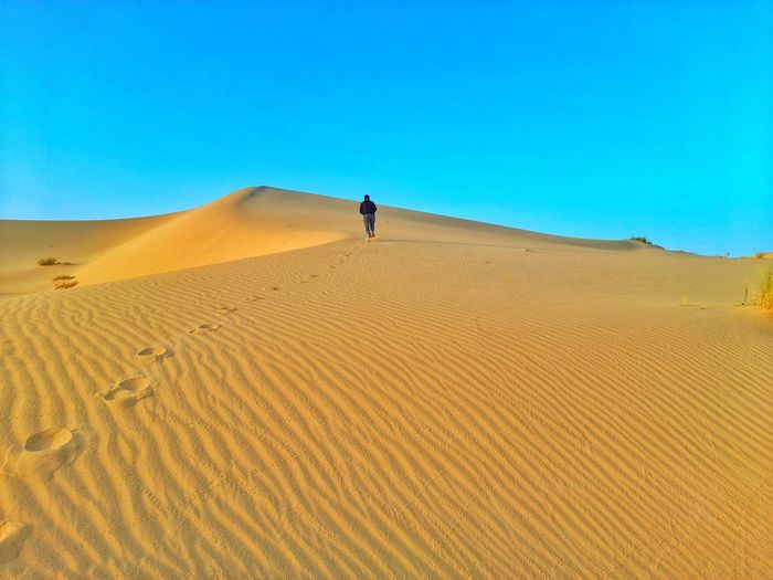 Walking on sand dunes on desert