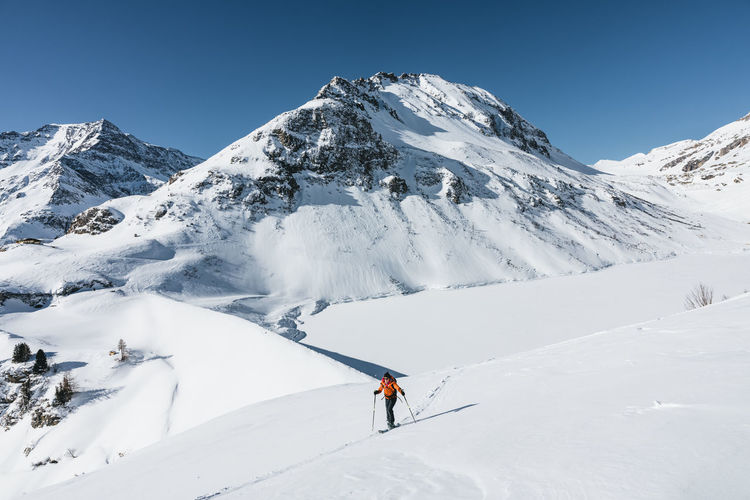 Woman ski touring in winter wonderland in the austrian alps, gastein, salzburg, austria