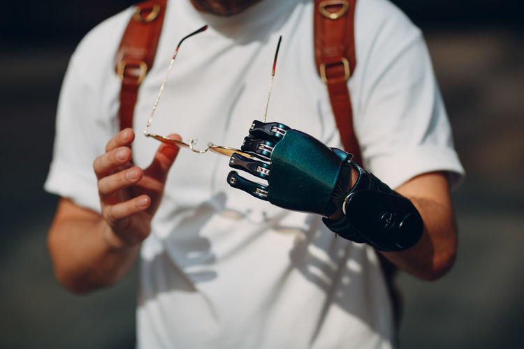 Midsection of man holding camera