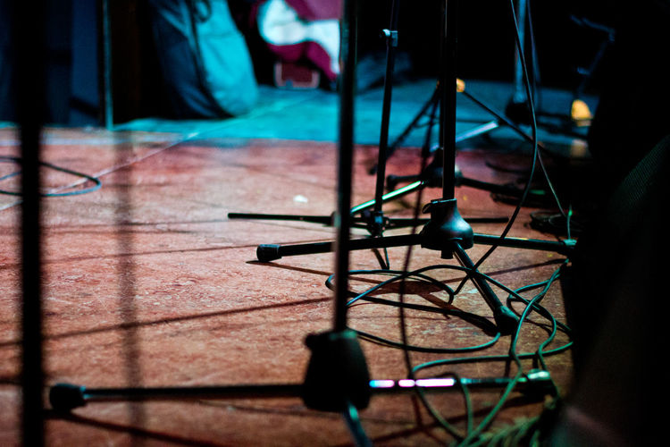 Close-up of tripods on stage