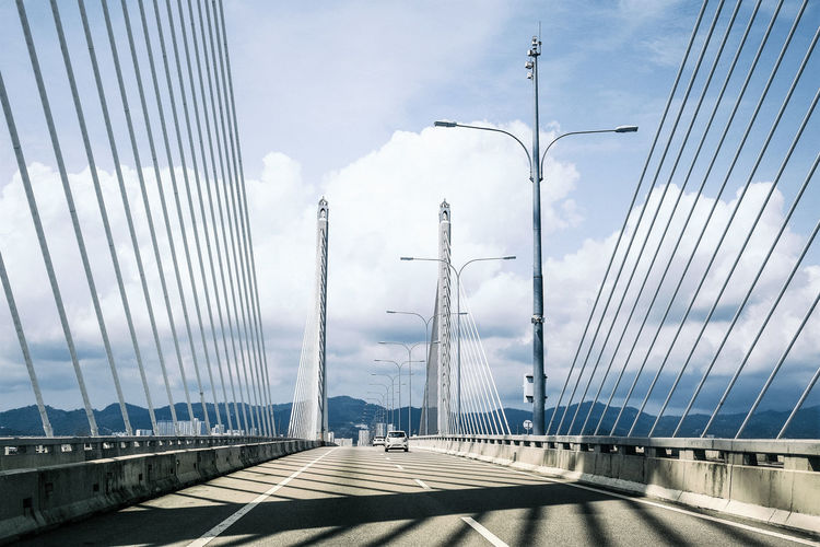 Driving across cable stayed bridge towards the city