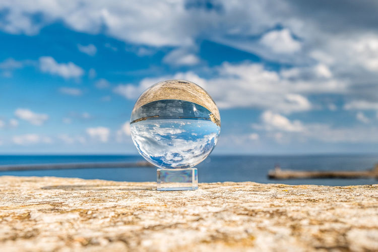 Crystal sphere against sky and sea