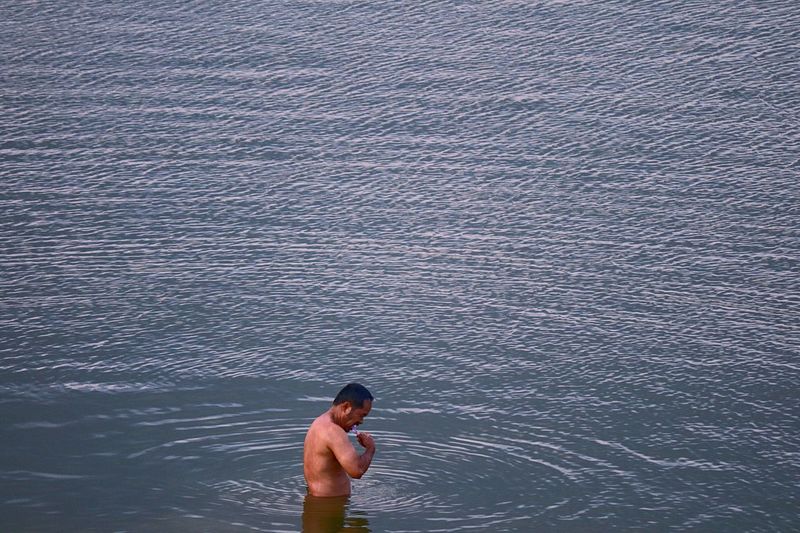 Side view of man standing in sea 
