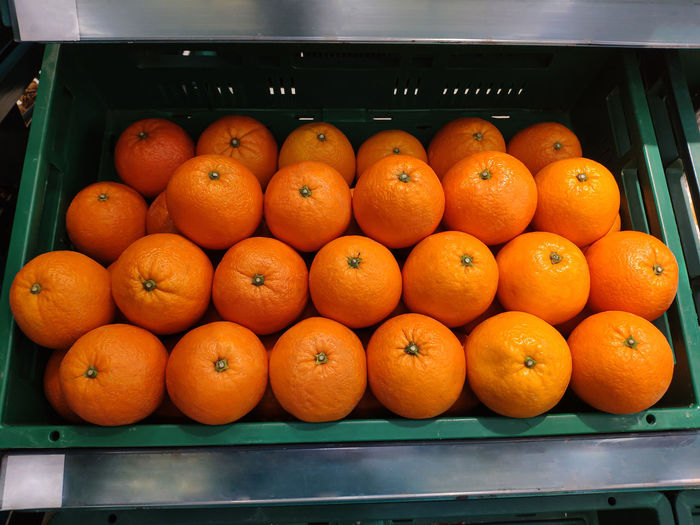Oranges on basket in supermarket.