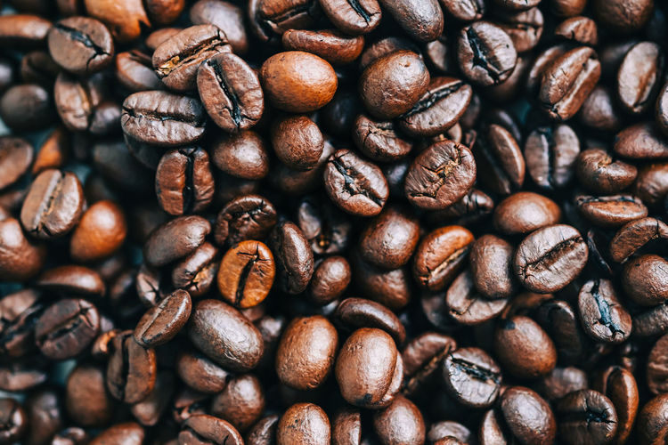 Roasted coffee beans background, top view.