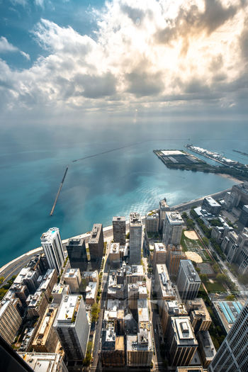 High angle view of buildings by sea against sky, chicago landscape
