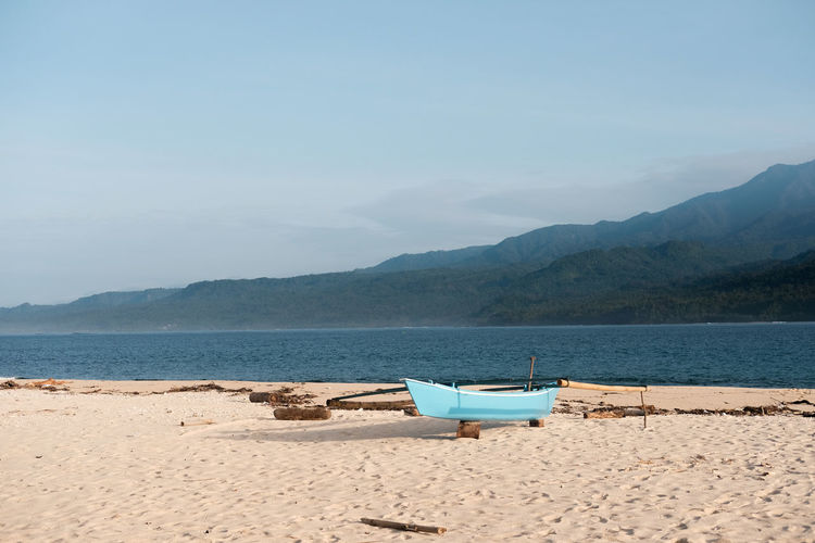 Boat on the banana beach with clean sand