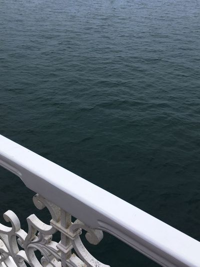 High angle view of metal railing by sea