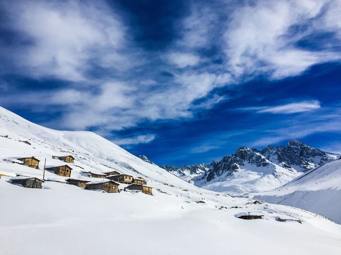 Scenic view of cottages on mountain in winter