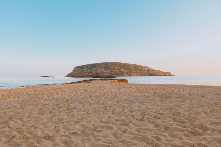 Scenic view of beach against clear sky