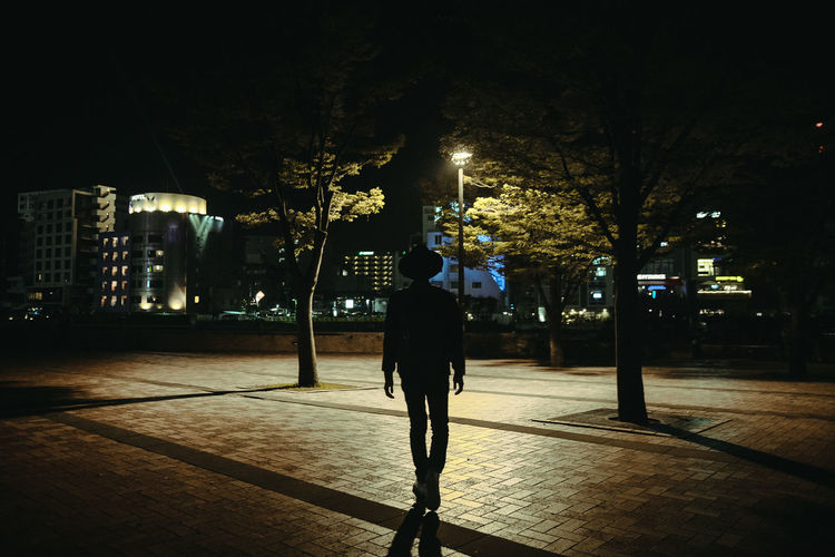Full length of man walking in city at night