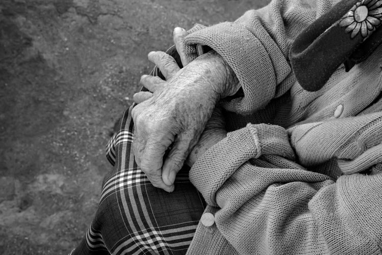 Senile hands of an old woman in black and white