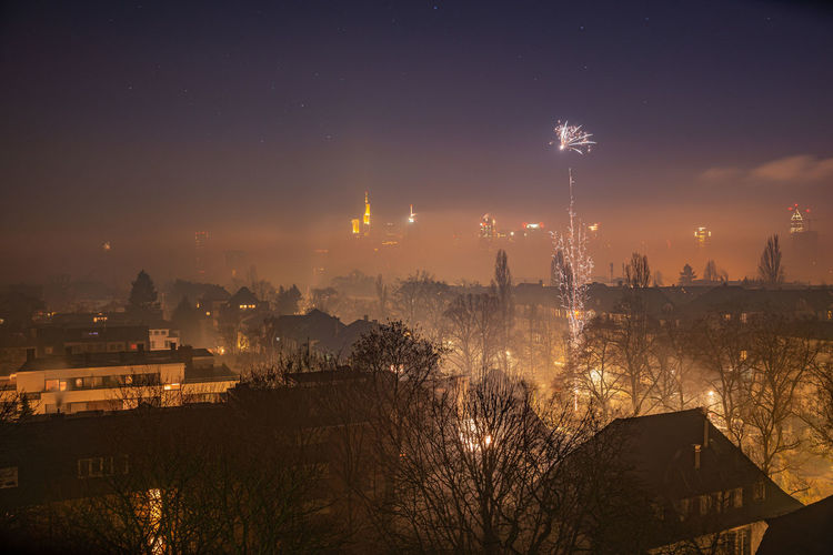 High angle view of city lit up at night