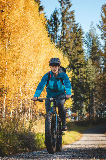 Recreational cyclist rides through the vuokatti arena in beautiful autumn weather and at sunset.