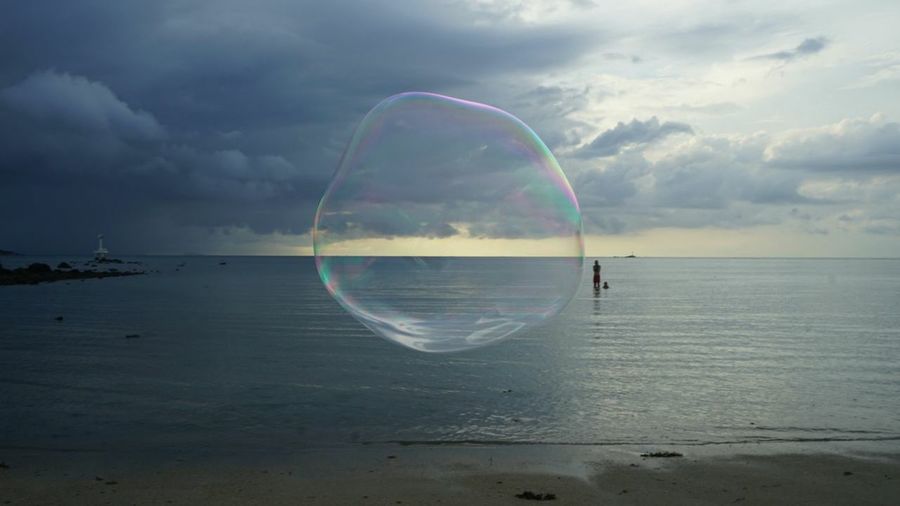 Scenic view of bubbles over sea against sky