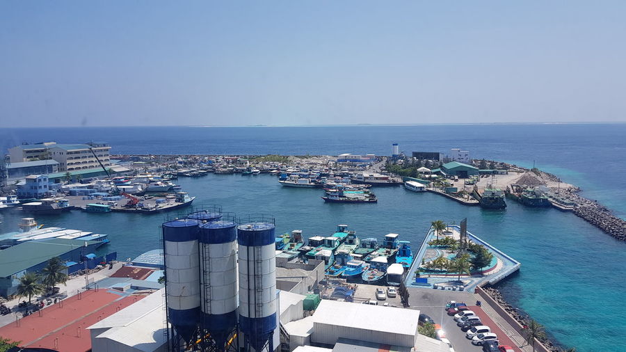 High angle view of harbor by sea against clear sky