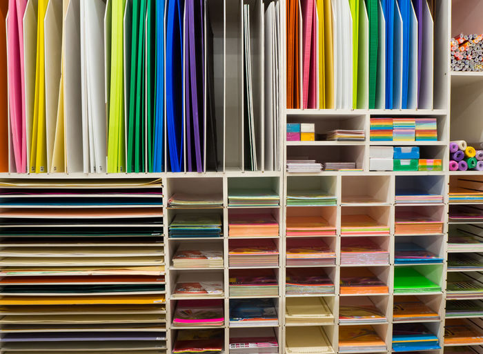 Colorful paper on shelf in store