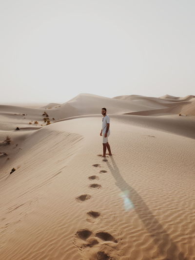 Full length of man on sand dune