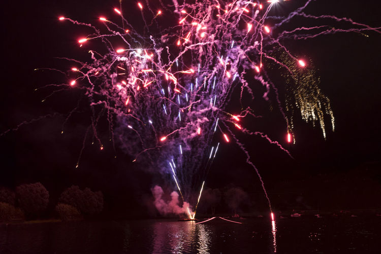 Firework display over lake at olympiapark during night