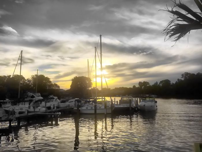 Sailboat in sea at sunset