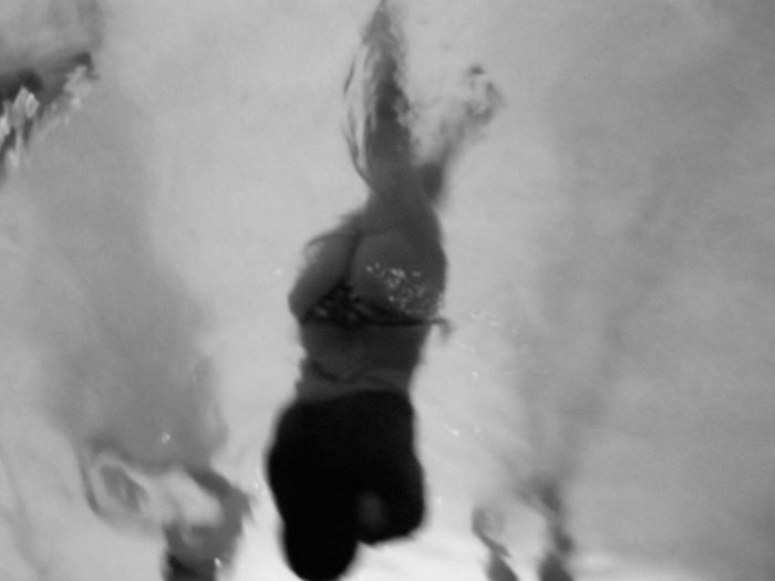 High angle view of woman swimming underwater