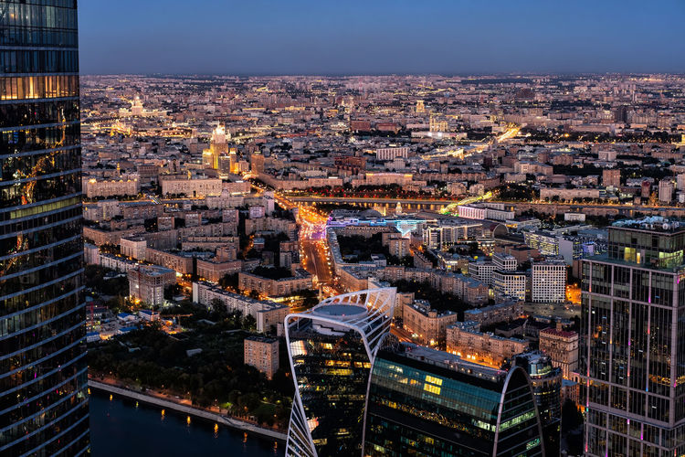 Aerial view of illuminated buildings in city at night