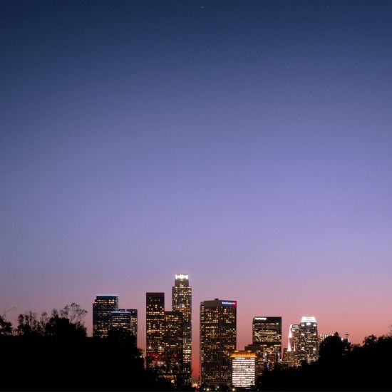 Illuminated cityscape against clear sky