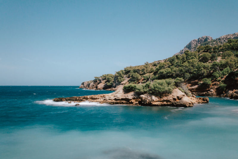 Scenic view of sea against clear blue sky