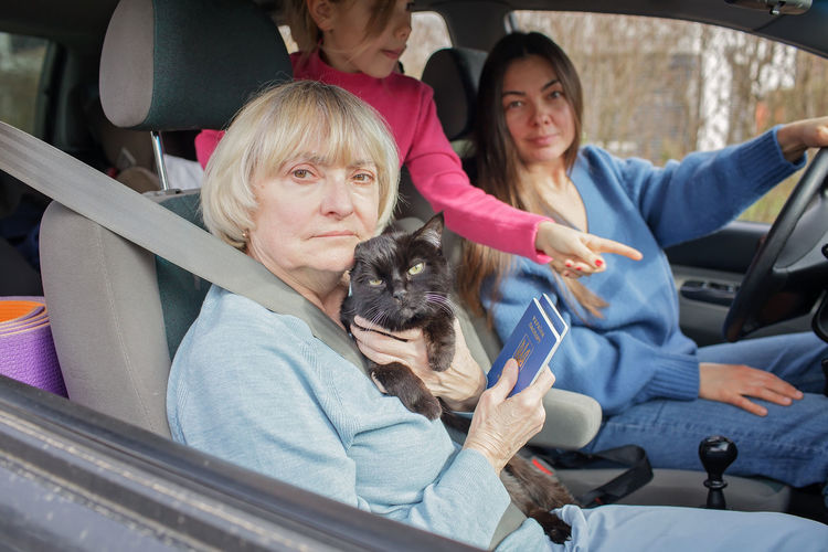 Ukrainian refugees flee from russian invasion, cross board by car together with pet, seek protection