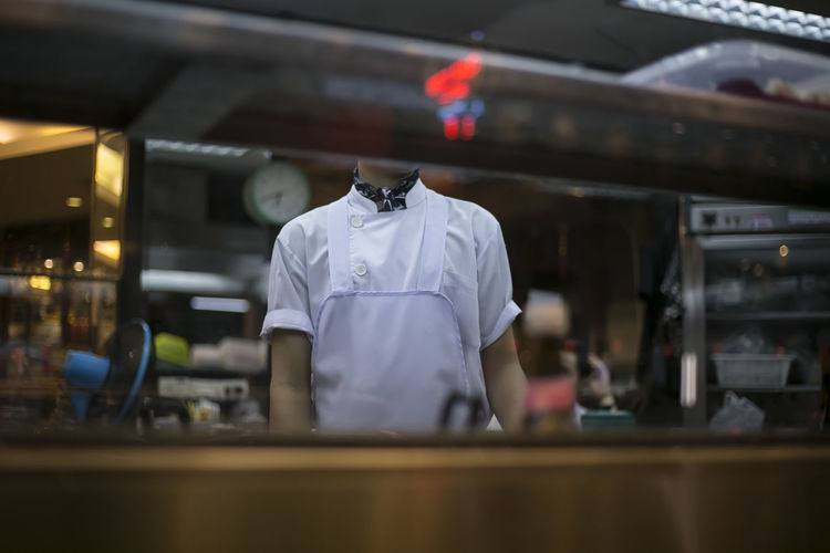 Midsection of chef standing in kitchen at restaurant