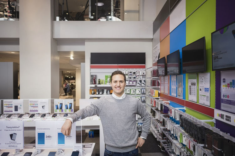 Portrait of man standing at store