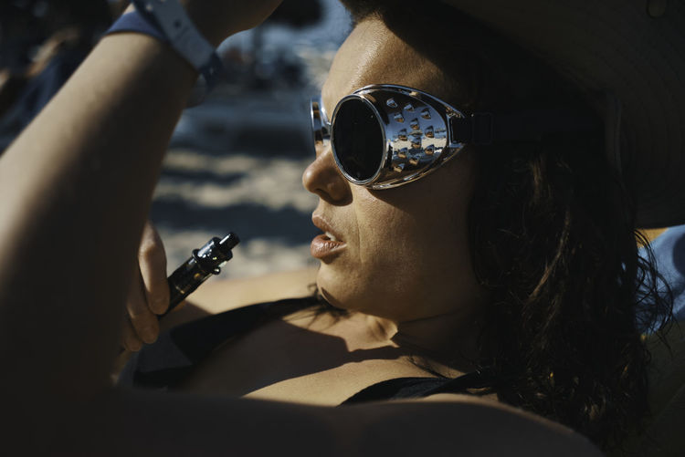 Portrait of woman holding sunglasses
