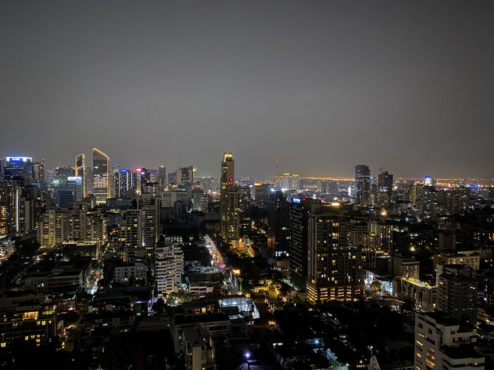 Illuminated bangkok cityscape against sky at night