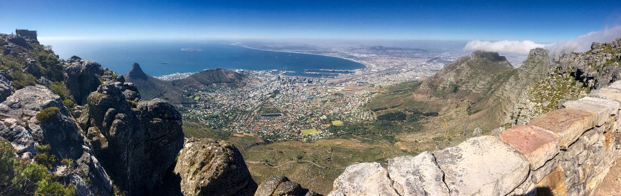 High angle view of sea and mountains against sky