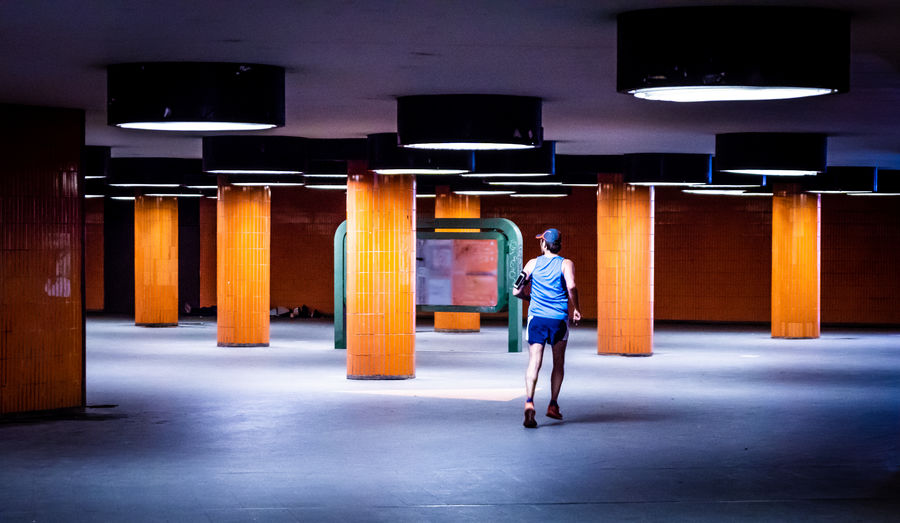 Man running in illuminated basement