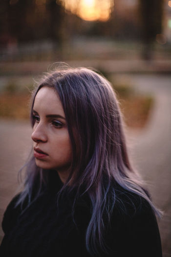 Portrait of hipster young woman with violet hair during autumn