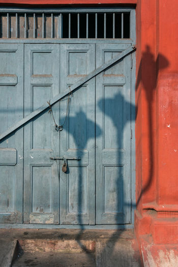 Full frame shot of closed door with shadows of street lamps