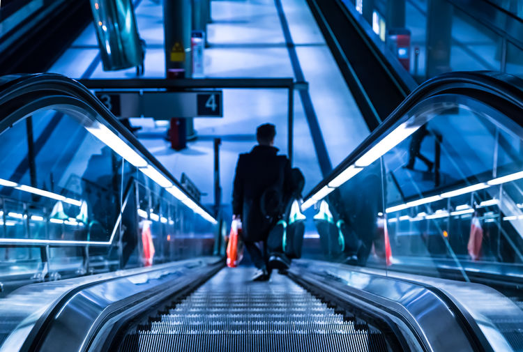 High angle view of man on escalator at railroad station