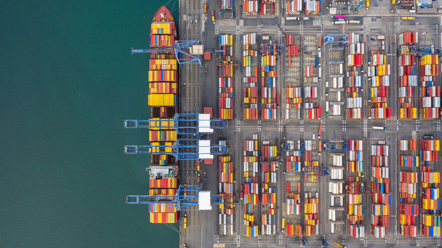 Aerial view of multi colored cargo container by lake