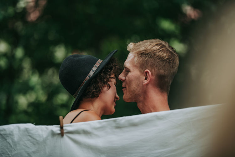 Portrait of young couple kissing outdoors