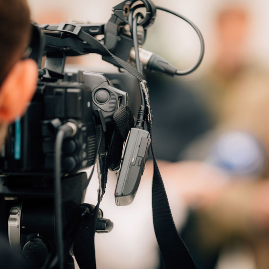 Cropped hand of man holding camera